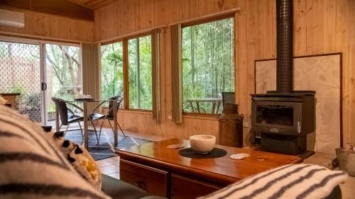 a living room with a fireplace and a stove at Treetops Montville in Montville