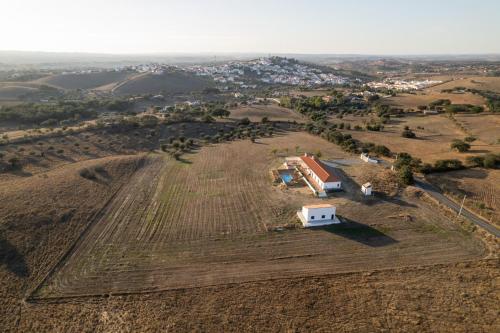 an aerial view of a field with a white house at Monte das Mós in Ourique