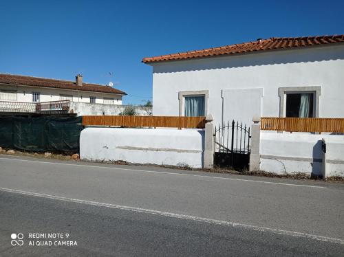 a white house on the side of a road at Casa da Professora in Vendas de Maria