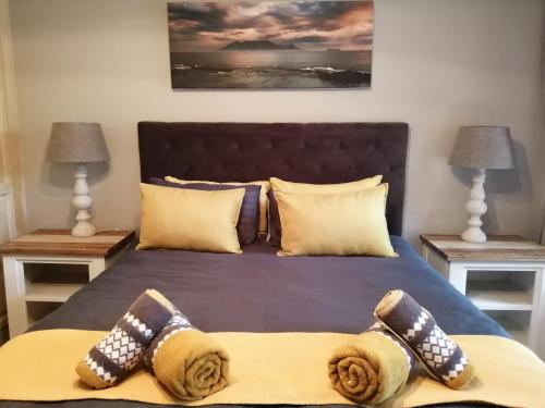 a bedroom with a bed with two night stands at Ikamu's lodge in Germiston