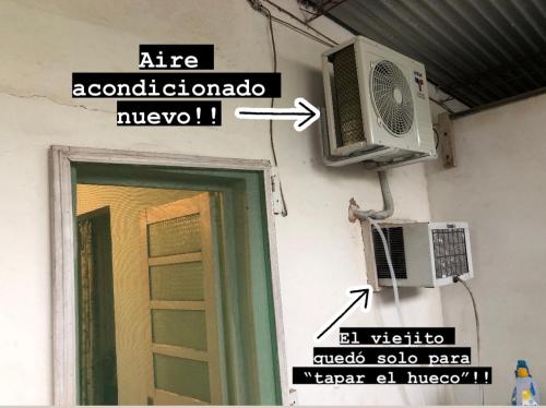 a door with a air conditioner and a fan on a wall at La Susy in Salto