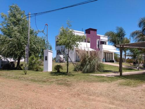 una casa con un edificio rosa y blanco en Chajari Suites en Chajarí