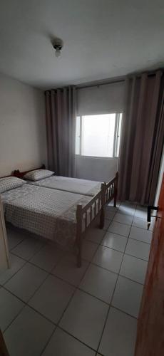 a bedroom with two beds and a window at Minha Casa, Seu Hostel in Recife