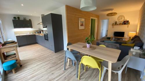 une cuisine et un salon avec une table et des chaises dans l'établissement Côté lac, à Gérardmer