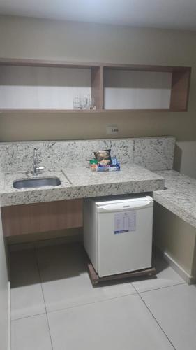 a kitchen with a counter with a sink and a dishwasher at Flat 427, Imperial Flat Tambau NOBILE in João Pessoa