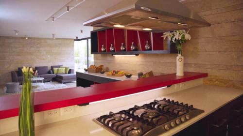 a kitchen with a stove top oven next to a living room at Central Apartamentos Bogotá in Bogotá