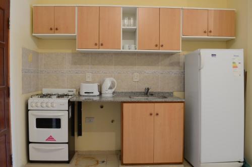 a kitchen with a stove and a refrigerator at B3 Apartments in Formosa