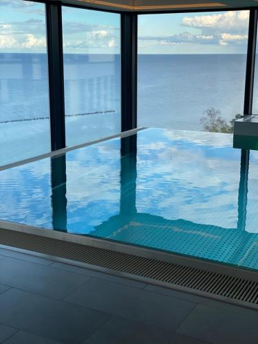 a view of a swimming pool from a window at Viktoria Deluxe direkter Meerblick in Ostseebad Sellin