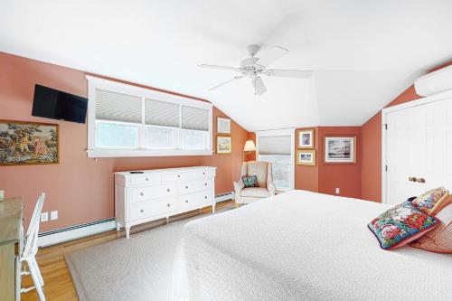 a bedroom with a white bed and a window at Rockledge in Clark Island