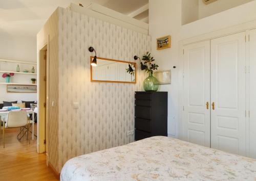 1 dormitorio con 1 cama y 1 dormitorio con mesa en Lovely apartment in Seville city center, Parking Optional, en Sevilla