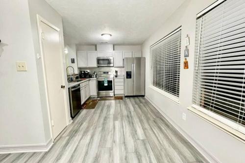a kitchen with white appliances and a hard wood floor at 3 Bedroom Entire Home - Centrally located in Katy, Texas in Katy