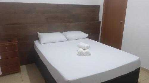 A bed or beds in a room at Pousada Mendonça