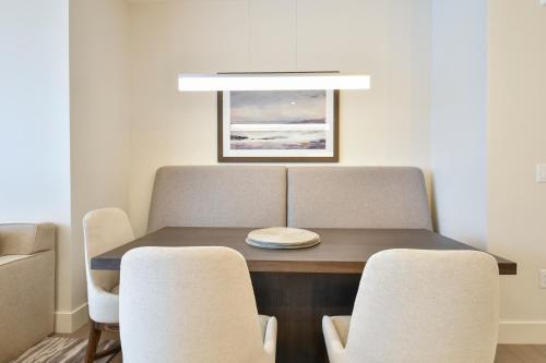 a dining room table with chairs and a plate on it at Lift Park City Condominiums in Park City