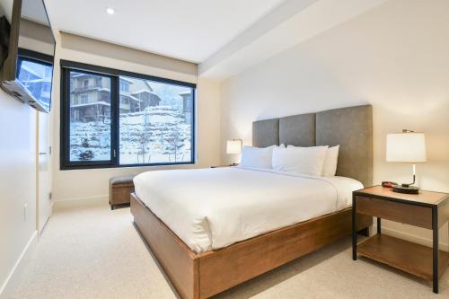 a bedroom with a large bed and a window at Lift Park City Condominiums in Park City