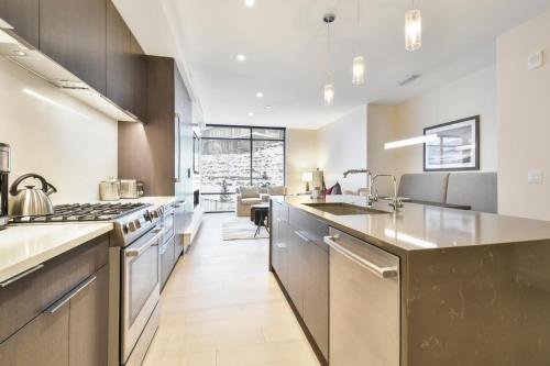 an open kitchen with stainless steel appliances and a living room at Lift Park City Condominiums in Park City
