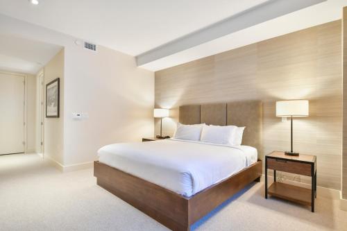 a bedroom with a large bed and two lamps at Lift Park City Condominiums in Park City