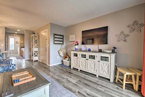 a living room with a flat screen tv on a wall at 5 Mi to Marvel Cave Ground-Level Branson Apt! in Branson