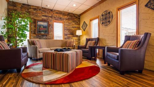 a living room with a couch and chairs and a rug at Best Western Center Pointe Inn in Branson