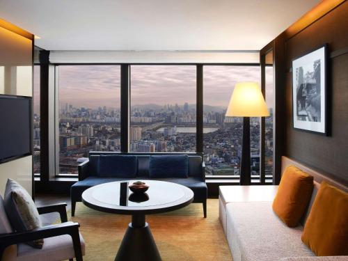 a living room with a couch and a table at Grand Hyatt Seoul in Seoul
