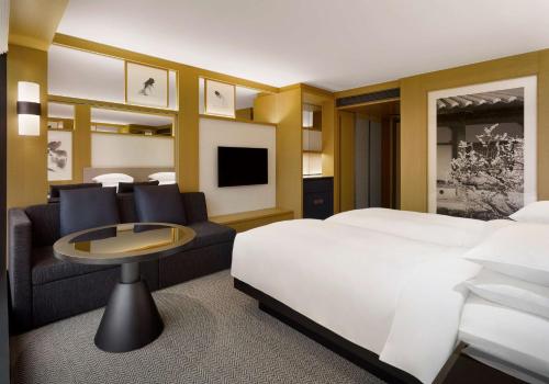 a hotel room with a bed and a couch at Grand Hyatt Seoul in Seoul