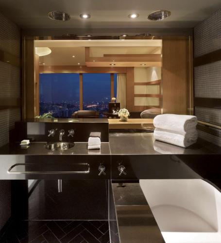 a bathroom with a sink and a large mirror at Grand Hyatt Seoul in Seoul