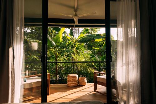 a room with a sliding glass door to a patio at La Prometida in Puerto Viejo