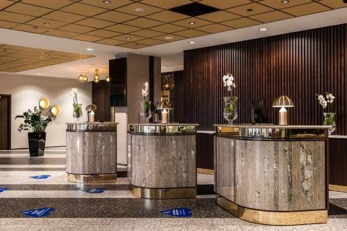 a lobby with a row of metal trash cans at Radisson Blu Hotel, Oulu in Oulu