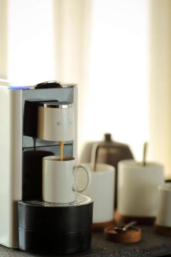 a group of coffee cups sitting on a counter at Radisson Blu Bali Uluwatu in Uluwatu