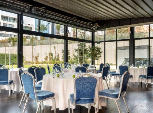 a conference room with tables and chairs and windows at Radisson Blu Hotel Istanbul Asia in Istanbul