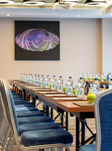 a long table with chairs and bottles of water at Radisson Blu Hotel Istanbul Asia in Istanbul
