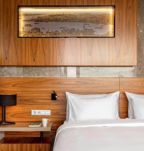 a bedroom with a bed with a wooden headboard at Radisson Blu Hotel Istanbul Asia in Istanbul