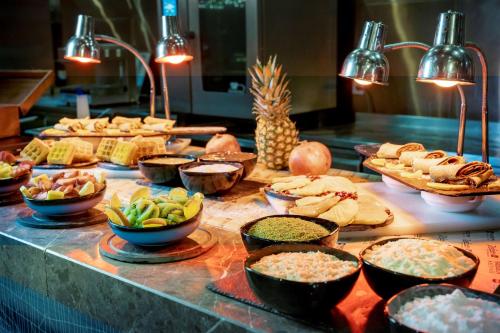 a buffet with different types of food on a table at Radisson Blu Hotel Istanbul Asia in Istanbul