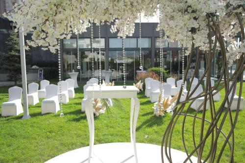 a bunch of white chairs and a table with flowers at Radisson Blu Hotel Istanbul Asia in Istanbul