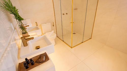 a bathroom with a shower and a toilet and a sink at Paraiso Beach Hotel in Aquiraz