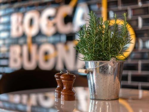 a vase with a plant in it sitting on a table at Radisson Hotel Zurich Airport in Rümlang