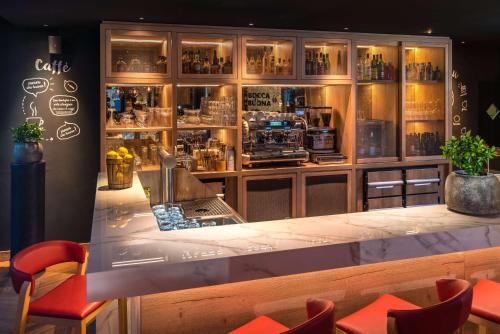 a bar with a counter in a restaurant at Radisson Hotel Zurich Airport in Rümlang