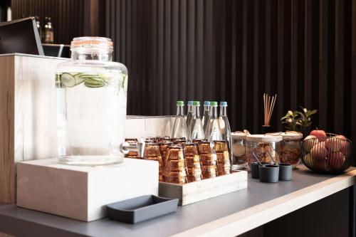 a table with a large bottle of water and some drinks at Radisson Hotel Zurich Airport in Rümlang