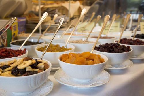 a row of bowls of food on plates on a table at Hotel Villa Marsili in Cortona