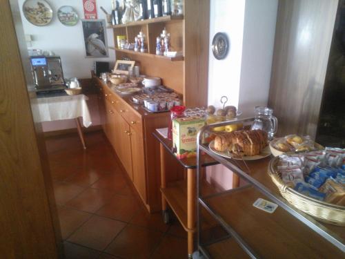 a kitchen with a table with food on it at Hotel Serenella in Canale San Bovo