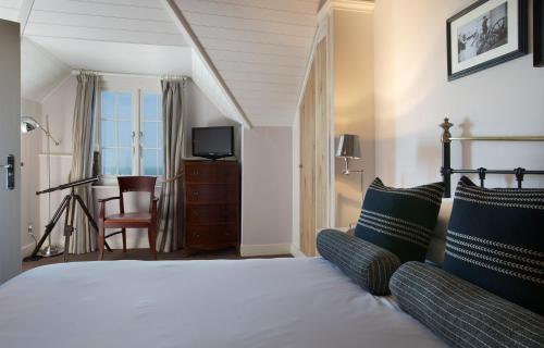 a hotel room with a bed and a television at The Marine in Whitstable