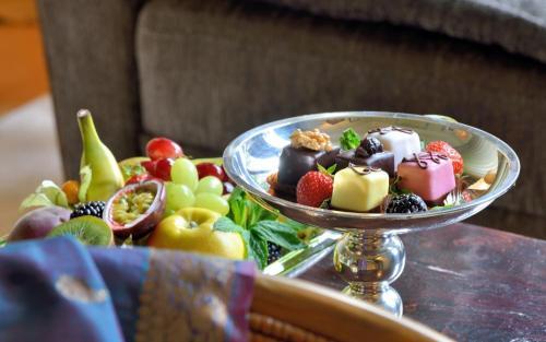 a plate of desserts on a table with fruit at Privathotel Lindtner Hamburg in Hamburg