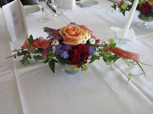 a vase filled with flowers on a table at Hotel Am Sonnenhang in Kassel
