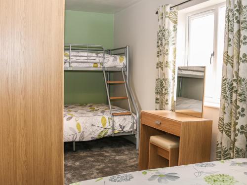 a bedroom with two bunk beds and a desk at Providence Apartment in Epworth