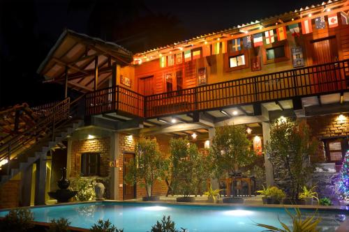 a building with a swimming pool at night at Negombo The Nature Villa and Cabanas in Negombo