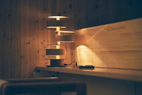 a group of lights hanging from a wooden wall at Shonai Hotel Suiden Terrasse in Tsuruoka