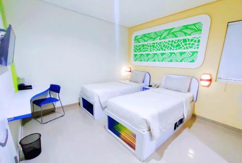Postel nebo postele na pokoji v ubytování Cordex Hotel Ancol