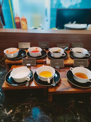 a group of bowls of soup on plates on a table at Swiss-Belhotel Cendrawasih, Biak in Fandoi
