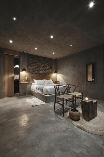 a bedroom with a bed and a table in it at Casa Michaus Valle de Guadalupe in Valle de Guadalupe