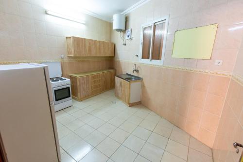 a small kitchen with a sink and a stove at العييري للوحدات المفروشة المدينة 3 in Al Madinah