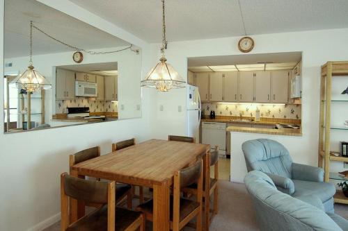 オーシャンシティにあるGolden Sandsの木製のテーブルと椅子のあるキッチンとダイニングルーム
